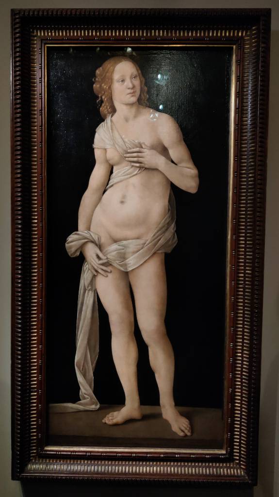 Peinture d'une femme quasi nue (une bande drapée transparente va de son épaule à sa hanche en passant par son pubis), une main sur un sein